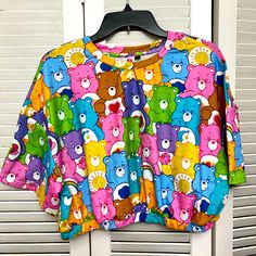 Women’s Care Bears Crop Top With Elastic Bottom. Never Worn, No Tags Carebears Clothes, Spring Beach Tops With Cartoon Print, Playful Multicolor Tops For Loungewear, Cute Multicolor Tops For Vacation, Cute Multicolor Tops With Rainbow Print, Cute Multicolor Vacation Tops, Cute Multicolor Rainbow Print Tops, Multicolor Cartoon Print Beach Tops, Cute Multicolor Loungewear Tops