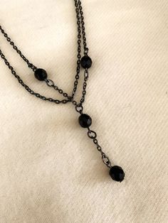 This black bead necklace has two 16" chains.  On one of the chains hangs an extra 1 3/4 inch extension with 2 of the 4 beads.  It has a nice sturdy clasp and is sure to please! Thank you for considering my items! So How Can I Say This Vintage Item Has Never Been Worn??? Most of the jewelry I sell is from a warehouse/business buy-out purchased from a retired jewelry wholesaler who did business from the 1970s thru the 1990s --- so has never been worn or sold at retail - only stored!  Much of this Black Metal Jewelry With Ball Chain, Black Metal Dangle Chain Necklace, Black Dangle Clavicle Chain Jewelry, Black Double Strand Beaded Necklaces For Jewelry Making, Black Dangle Jewelry With Adjustable Chain, Black Chain Necklace With Round Beads For Gift, Black Round Beads Chain Necklace As Gift, Black Metal Double Chain Necklace, Black Double Strand Necklace With Beads