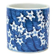 a blue and white vase with flowers painted on the inside of it's rim