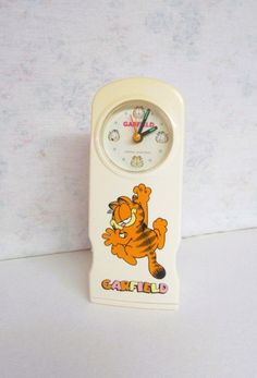 a white clock with garfield the cat on it