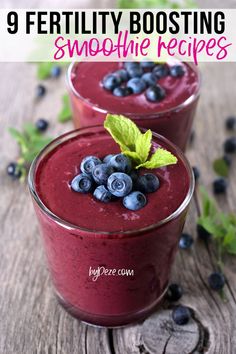 two glasses filled with blueberry smoothie and mint sprigs on the side