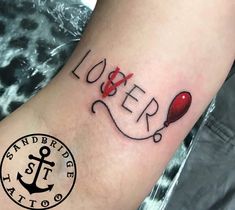 a tattoo with the word lover on it and an anchor in red ink is shown