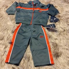 Grey Red Nike Track Suit / Sweatsuit 2pc Set- Size 12m Nike Sets For Winter Playwear, Fitted Orange Playwear Sets, Nike Red Playwear Sets, Nike Sporty Sets For Playtime, Sporty Fitted Sets For Playwear, Nike Fitted Sports Sets, Fitted Nike Sports Sets, Nike Fitted Sportswear Sets, Toddler Nike Outfits