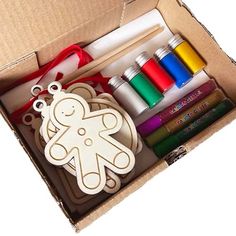 an open cardboard box filled with craft supplies