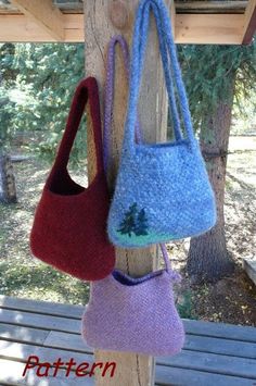 three purses hanging from a wooden post