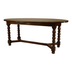 an oval wooden table with turned legs