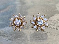 Metal: 14k Yellow Gold Stones: Diamonds (2) Two Diamond Studs Cut: Round Brilliants Color: I Colors Clarity: SI1 Carat: .75 carats total weight (2) Two Diamond Earring Jackets: Each Jacket Contains (9) Nine Diamonds Cut: Marquis Cuts Color: I Colors Clarity: SI2 Carat: Approximately 1.50 carats total weight These beautiful diamond stud earrings can be worn alone... or if you would like to dress them up, the stunning marquis diamond jackets complement and enhance the look. They are handmade and l Diamond Jacket Earrings, Marquis Diamond, Diamond Earring Jackets, Cluster Earring, Marquise Earrings, Locket Design, Light Jewelry, Diamond Cluster Earrings, Earring Jackets