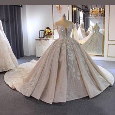 a wedding dress on display in front of other gowns and bridal gowns