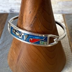 "Vintage Silver Toned Zuni Mother of Pearl and Enamel Inlaid Cuff Bangle Bracelet  Beautiful vintage Zuni bangle bracelet. It's silver toned, front openable with a hatch, featuring colourful enamelled panel with mother of pearl bits inlaid. Hallmarked Mexico underneath the front. Beautiful vintage condition. Measurements  Diameter: 6cm/2.3\"	in stock	88.35 USD	"	10.61 USD	Jewelry > Bracelets > Cuff Bracelets
https://i.etsystatic.com/11254531/r/il/bb7bd9/3803358263/il_fullxfull.3803358263_gqz7.jp Horn Necklace, Cuff Bangle Bracelet, Cuff Bangles, Mother Of Pearl, Vintage Silver, Bangle Bracelets, Cuff Bracelets, Silver Tone, Jewelry Bracelets