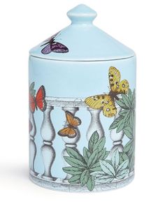 a blue jar with butterflies on it