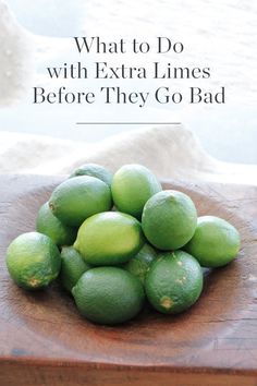 limes in a wooden bowl with the words what to do with extra limes before they go bad