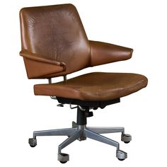 an office chair with brown leather upholstered seat