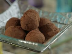 a glass bowl filled with chocolate truffles on top of a table