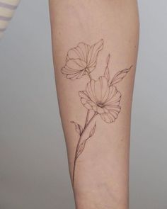 a woman's leg with a flower tattoo on her left calf and the bottom half of her thigh