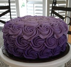 a purple cake sitting on top of a table