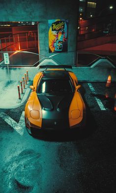 an orange and black sports car parked in front of a building