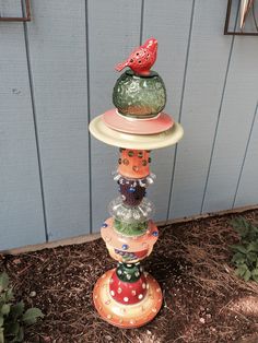 a stack of glass vases sitting on top of each other in front of a building