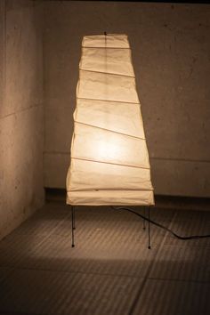 a lamp sitting on top of a wooden table in a room with no one around it