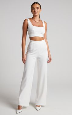 Stand out from the squad in our Elibeth Two Piece Set! This sleek and sophisticated going-out ensemble features a crop top with a square neckline and wide-leg pants that sit high on the waist then fall elegantly to the ankle. Dressy but easy to wear and style, it offers a fresh alternative to the party dresses and separates in your wardrobe.Wear it with trendy heels for a pop of colour, then round out your look with fine jewellery and a mini handbag!Product Details Top  Exposed metal zipper on the centre back  Adjustable straps, tapered from the front to back  Square neckline  Cropped curved hemline panel  Fully lined  No pocketsPants  Invisible side seam zip  Dart detailing on front  No belt loops  Wide legFull length  No pocketsSize & Fit  Size S / 8 top length: 31cm / 12in Pastel Two Piece Outfit, Two Piece Rehearsal Dinner Outfit, White Two Piece Outfit Pants, Wide Leg White Pants, White Matching Set, White Two Piece Outfit, Formal Crop Top, Tulum Outfits, Rehearsal Dinner Outfits