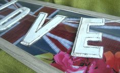 a wooden sign with the word love painted on it