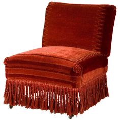 a red chair with fringes on it