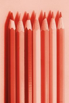 six pink pencils lined up in a row