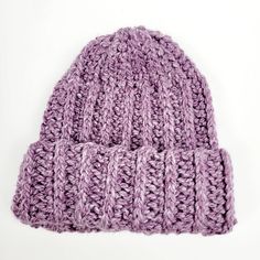 a purple knitted hat on a white background