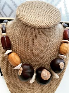 Beautiful natural chain crafted with beads of wood, metal, buck-eye seed, and shells. Bohemian Brown Shell Necklace With Wooden Beads, Nature-inspired Brown Beaded Necklaces, Unique Handmade Brown Shell Necklace, Brown Jewelry With Wooden Beads, Buck Eyes, Wooden Bead Jewelry, African Accessories, Wooden Beads, Jewelry Inspiration