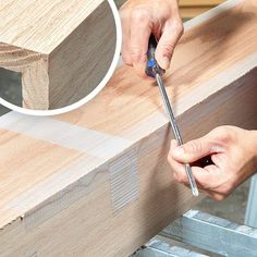 a person using a drill to cut wood