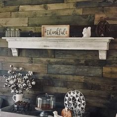 there is a shelf above the fireplace with some decorations on it and other items around