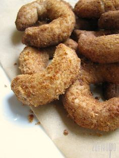 some fried doughnuts sitting on top of a piece of paper