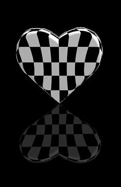 a black and white checkered heart shaped object with reflection on the floor in front of it