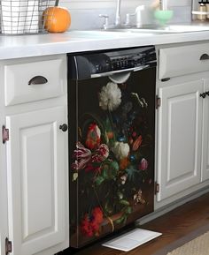 a dishwasher with a painting on it in a kitchen