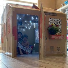 an open cardboard box sitting on top of a wooden floor