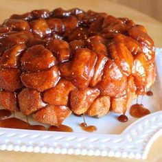 a bundt cake covered in caramel sauce on a white plate