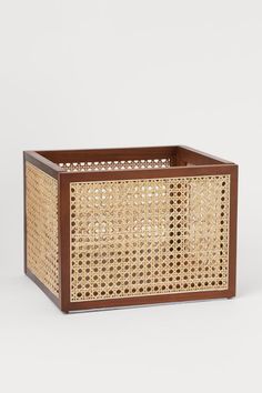 a brown basket sitting on top of a white table