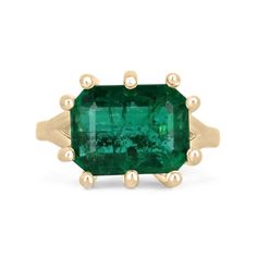 This solitaire ring boasts a breathtaking centerpiece in the form of a 6.12-carat emerald cut emerald. The emerald features a deep, rich green color that is truly stunning and displays outstanding characteristics. The emerald is set horizontally, east to west, in a unique and custom 10-prong setting crafted from luxurious 18k yellow gold. The setting showcases the beauty of the emerald while providing a secure and stylish way to display it on the finger. The overall effect is a ring that is both bold and elegant, perfect for those who want to make a statement with their jewelry. Setting Style: Prong-Solitaire  Setting Material: 18K Yellow Gold Setting Weight: 7.0 Grams Main Stone: Emerald Shape: Emerald Cut  Weight: 6.12-Carats Clarity: Semi-Transparent  Color: Deep Rich Green Luster: Very Emerald Solitaire Ring, Emerald Necklace Pendant, Secret Wedding, Loose Emeralds, Emerald Gem, Solitaire Setting, Real Jewelry, Etsy Gold Ring, Minimalist Gifts