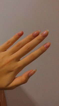 a woman's hand with pink manicures on it