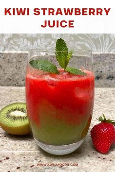 kiwi strawberry juice in a glass next to a sliced kiwi