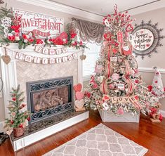 a decorated christmas tree in the corner of a living room next to a fire place