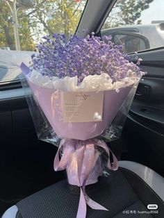 a bouquet of lavenders in the back seat of a car, wrapped in cellophane