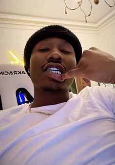 a young man brushing his teeth with an electric toothbrush