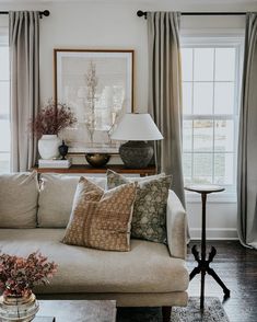 a living room filled with furniture and windows