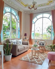 a living room filled with furniture and lots of window panes in front of them