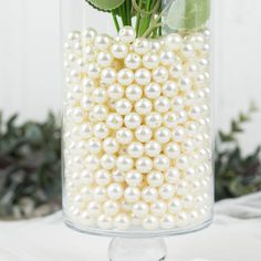 a vase with flowers and pearls in it