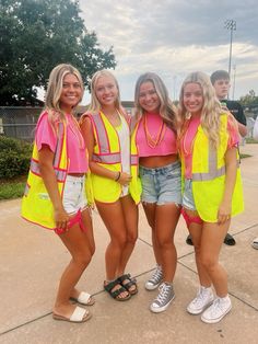 four girls in neon vests posing for the camera