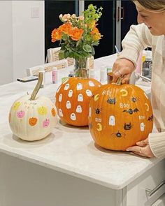 a woman is carving pumpkins for halloween