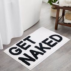 a bathroom rug that says get naked on it