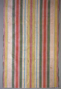 an old striped cloth hanging on the wall