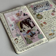 an open book with various stickers on the pages and writing in japanese characters,